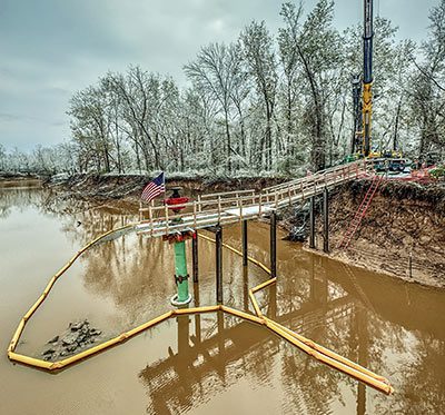 abandoned oil well sitting in water and emiting methane